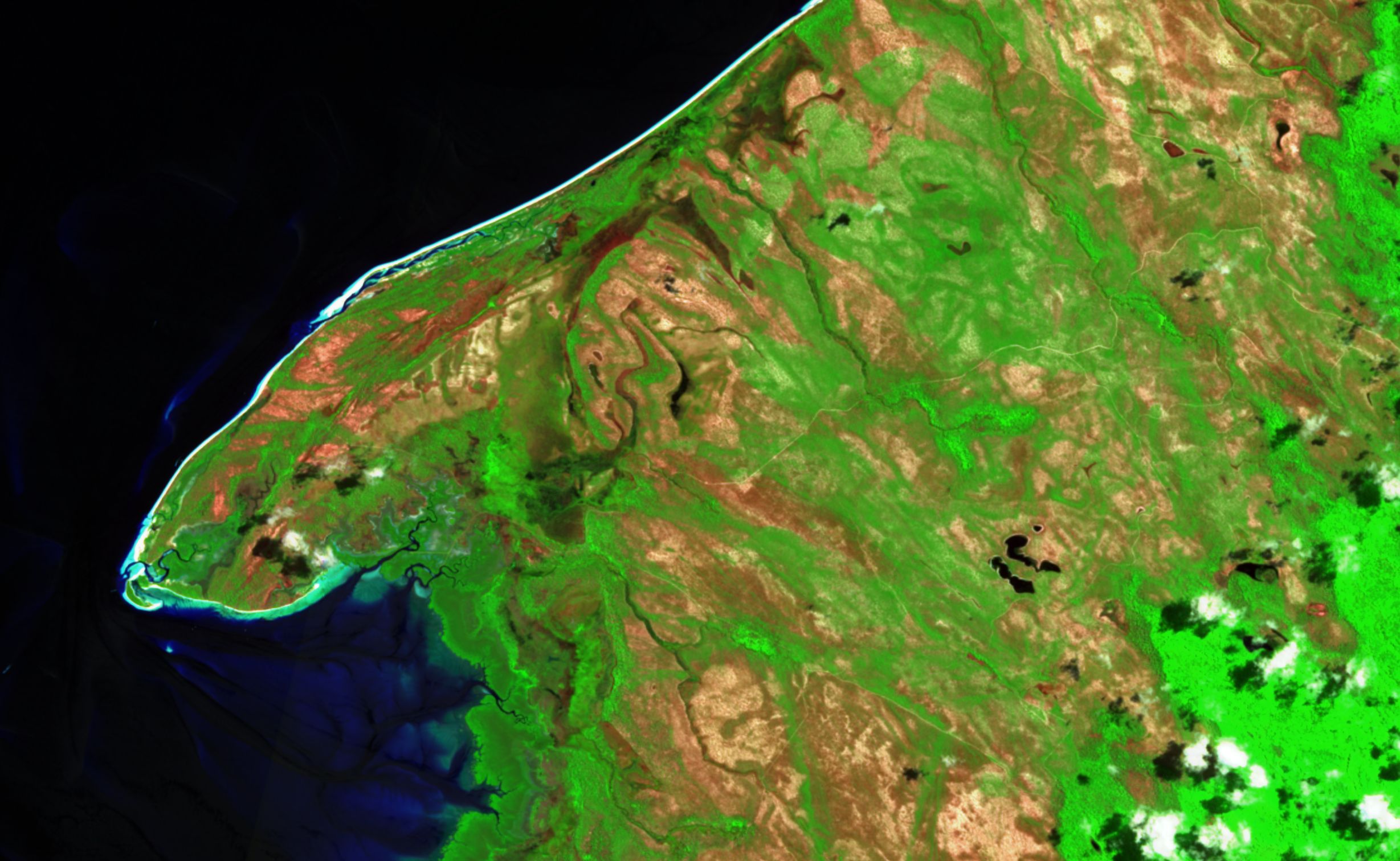 K’gari, Sentinel-2 SWIR composite, February 2021: the scar of the 2020 bushfire shows pink-brown across much of the island.
